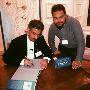 Dr AlKadi signing my copy of his book with the inscription: 'Preserving History for the Future Generations.'